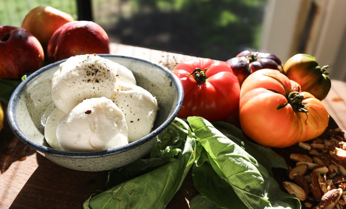 A vibrant summer salad of heirloom tomatoes, juicy nectarines, and creamy burrata